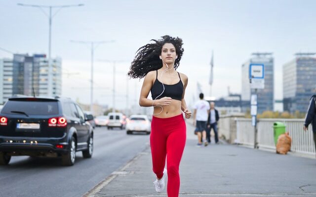photo-of-woman-listening-to-music-on-earphones-running-down