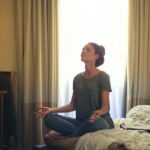 woman-meditating-in-bedroom