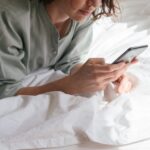 woman-using-smartphone-in-bed